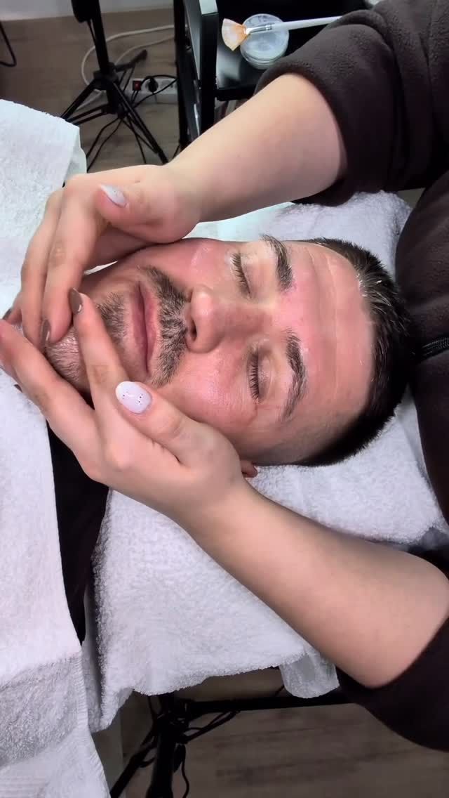 Entspannende Gesichtsmassage bei einem männlichen Kunden